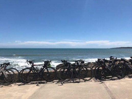 Bikes leaning against a sea front wall